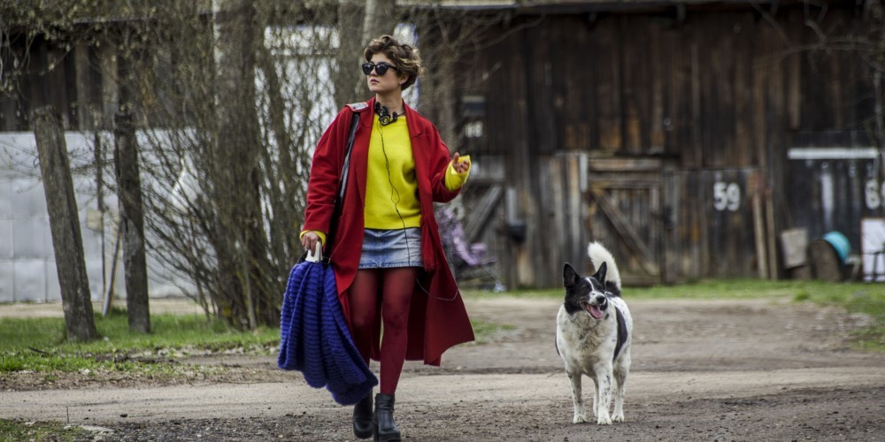 A woman walks a dog.