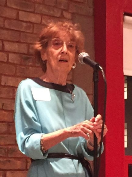 lenore dekoven talking at a microphone 