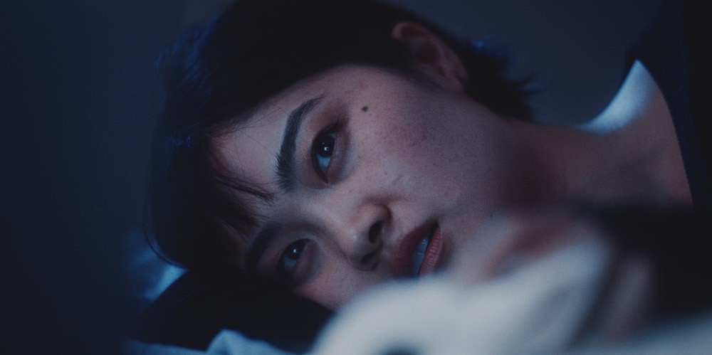 Woman lies on a pillow. 
