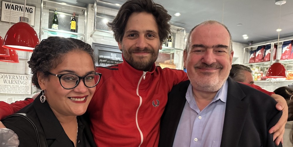 Alexander Molochnikov '25 celebrates his BAFTA award win with Film Program Chair Jack Lechner and Director of Academic Administration Hanna Seifu. Two men and a woman pose for a photo