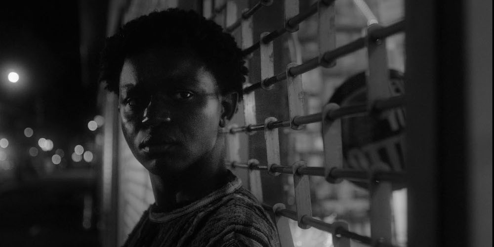 Still from 'Heaven is Nobody's' A boy stands against a grate