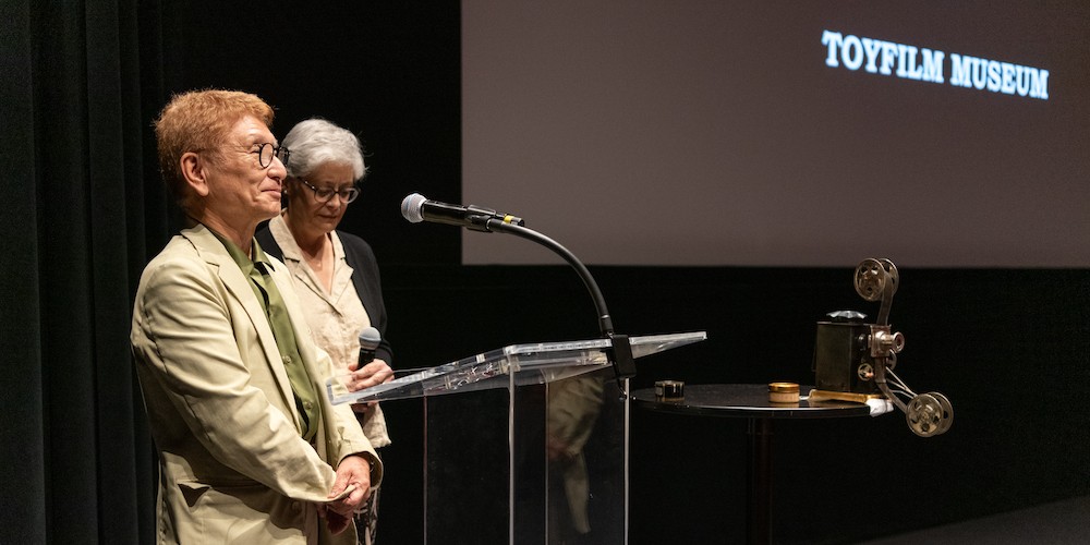 Yoneo Ota, Professor of Art and Curator of Kyoto's Toy Film Museum, gives opening remarks alongside translator Joanne Bernardi (GSAS ’92)