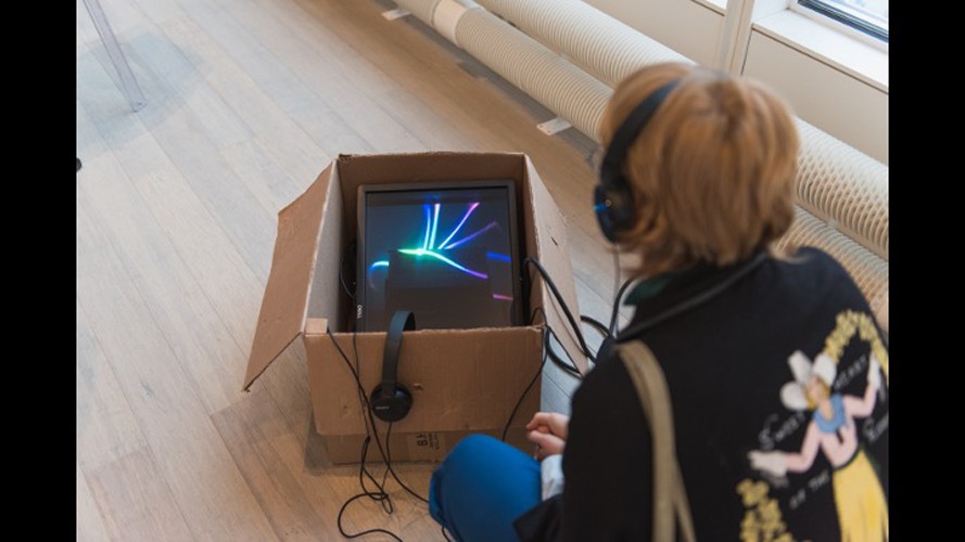 Art piece with a screen and headphones.