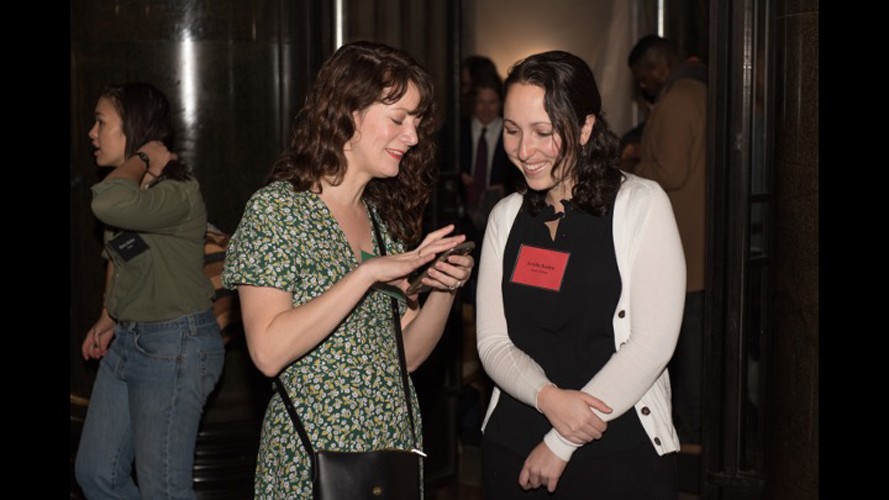 Two women talking at an event.