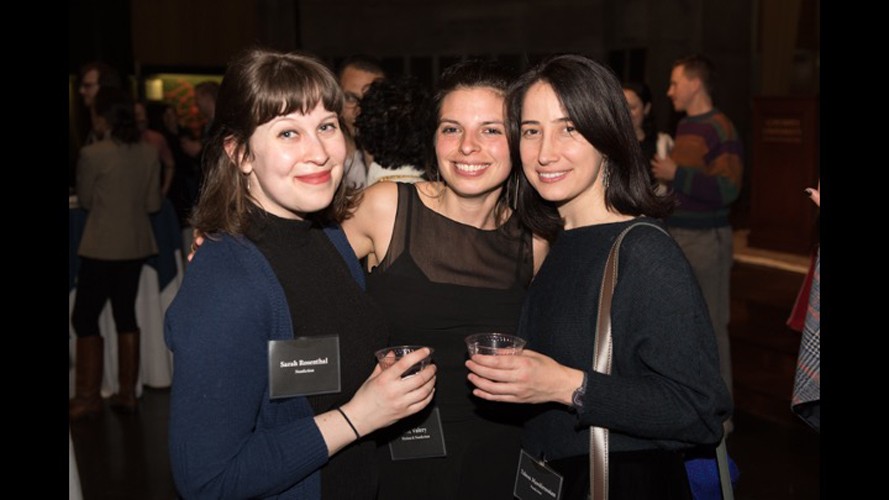 Three women posing at an event.