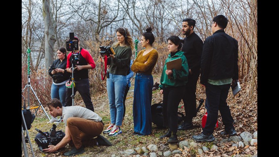 Group of students during a film shoot outdoors.