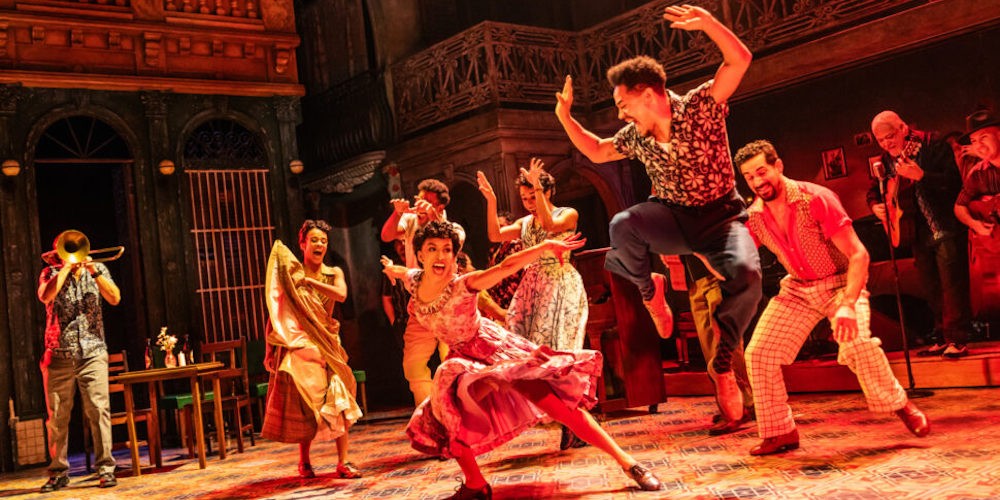 Actors dance on stage. 
