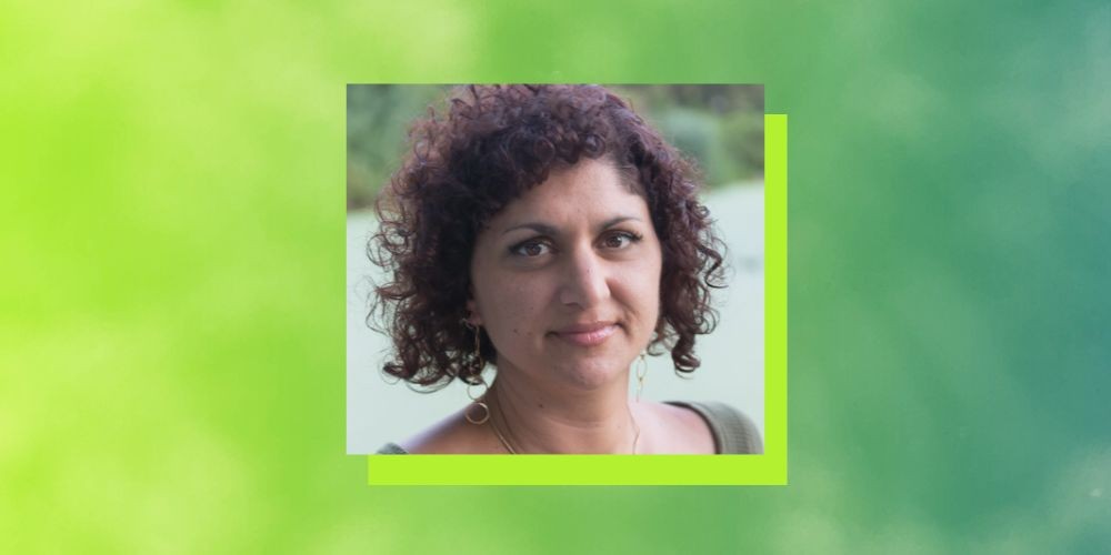 Headshot of woman with a bright green boarder. 