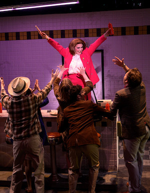 Woman in pink suit dancing. 
