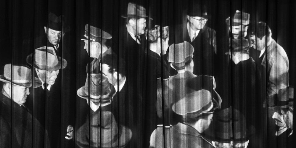 Many men wearing hats projected on textured surface