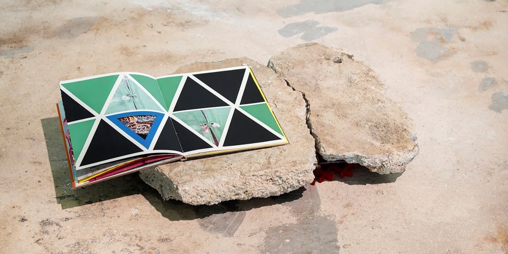A book on top of a rock.
