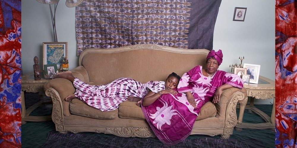Two women in purple clothes on a couch