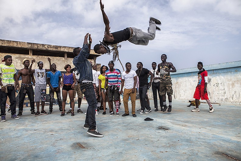 two people performing in front of a small crowd