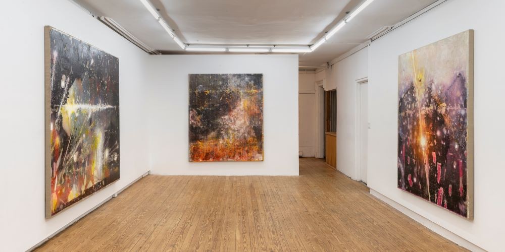 Three floor-to-ceiling paintings in a gallery