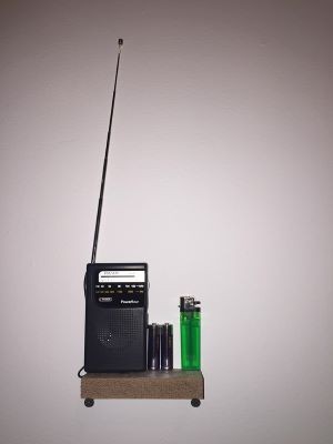 radio and lighter on a shelf
