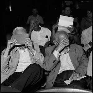 Former military men hide their faces from the photographer during a session of their trial in which they are being accused by the Argentine state of crimes against the Humanity in the last dictatorship from 1976-1983. Bahia Blanca, Argentina, February 2012. Courtesy the artist. Photograph by Joao Pina
