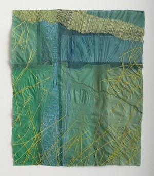 An art work made of what looks like fabric, green yellow and blue 