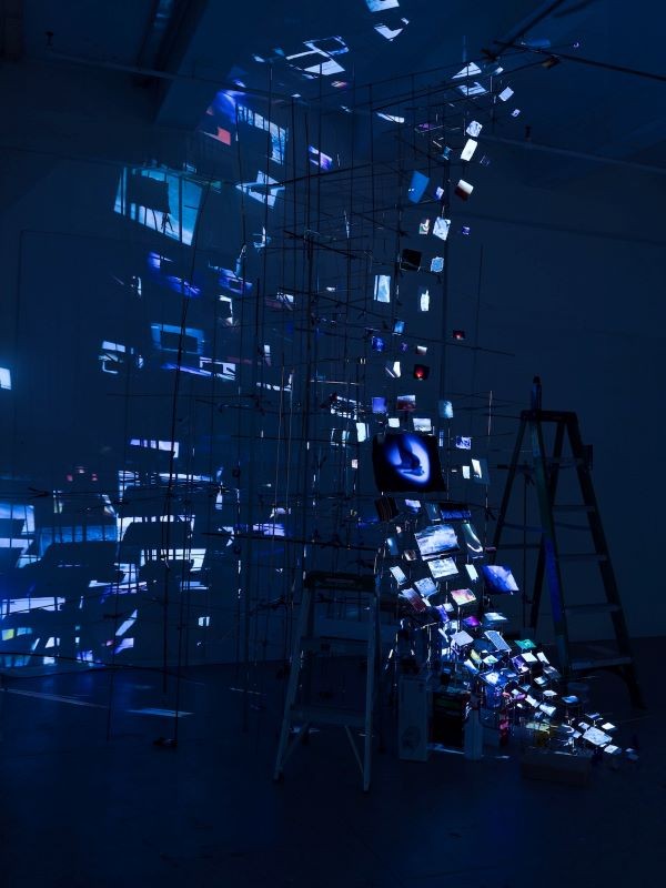 Installation of articulated prints illuminated by blue lights