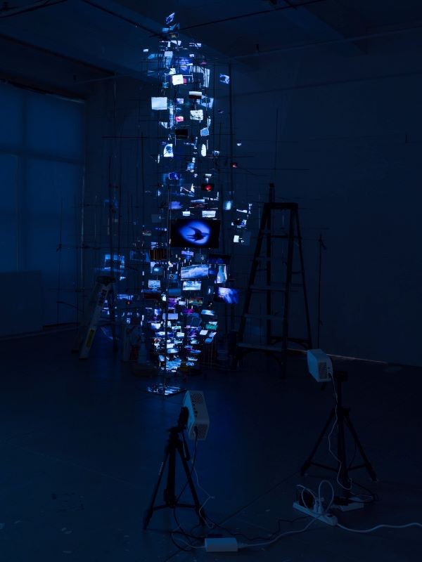 Installation of articulated prints illuminated by blue lights