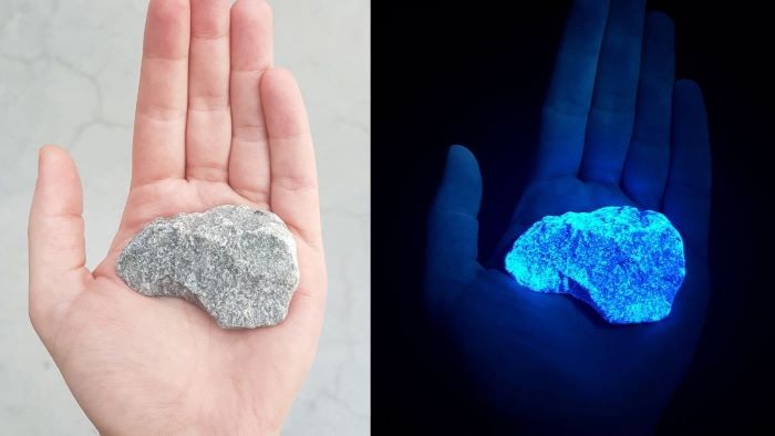 A hand holding a rock. The image on the right is in the dark and the rock is bioluminescent.