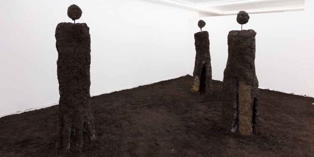 three humanoid sculptures as part of an art installation