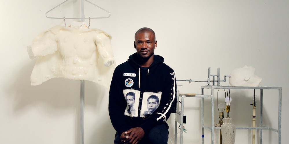 Jeffrey Meris stands next to artwork 