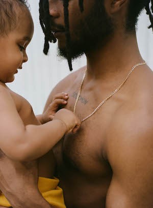 Closeup profile of a baby and young man. 