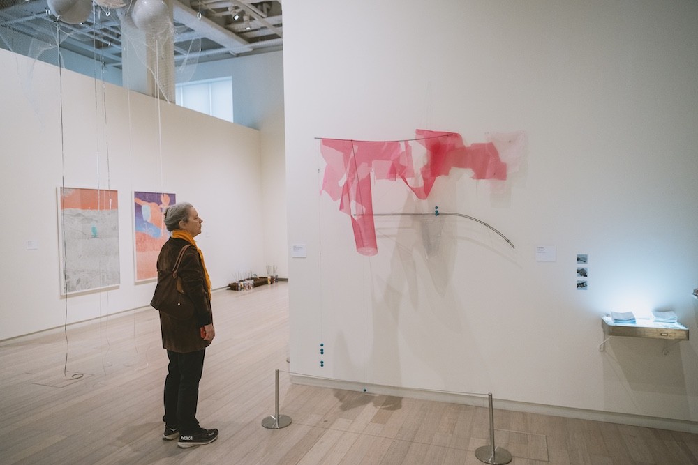 Person views art work.