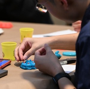 Person plays with Play Doh. 