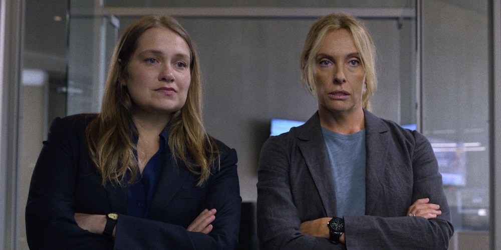 Two blond investigative women in suits