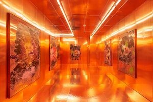 a bright orange space with lights and art