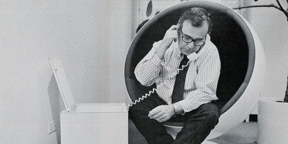 Black and white image of a man on the phone. 