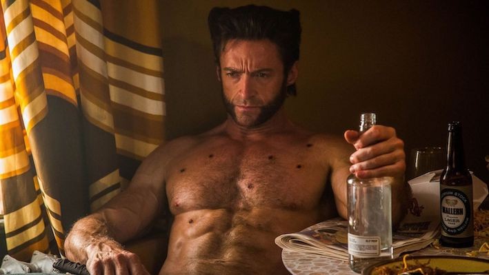 Wolverine sitting in a tub with chest wounds
