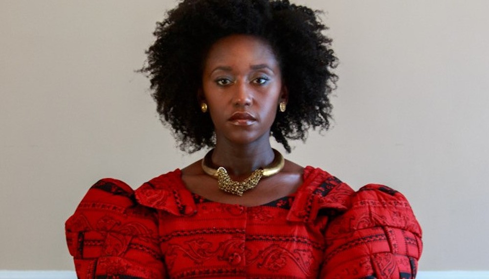 Black woman in red dress with poofy sleeves 