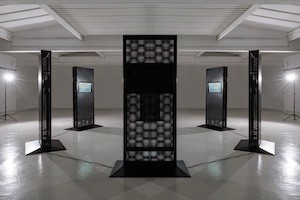 'Spectre,' by Bill Posters and Daniel Howe Ominous dark sculptures standing beside each other