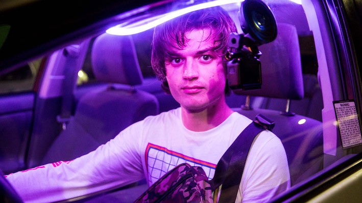Still from 'Spree,' image courtesy of Sundance Film Festival A man in a car with purple lights.