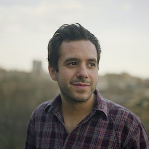 A man wearing plaid, smiling