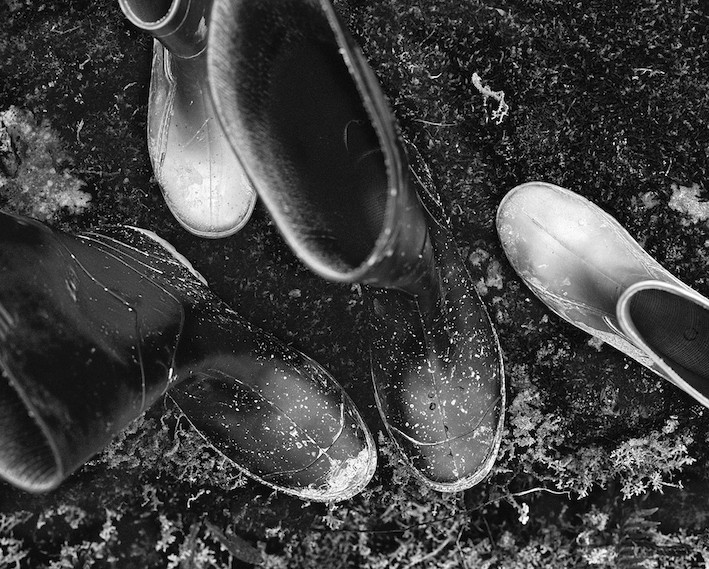 black and white image of rain boots