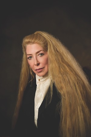 Portrait of the poet, looks like a painting, a white woman with long thick blond hair. 